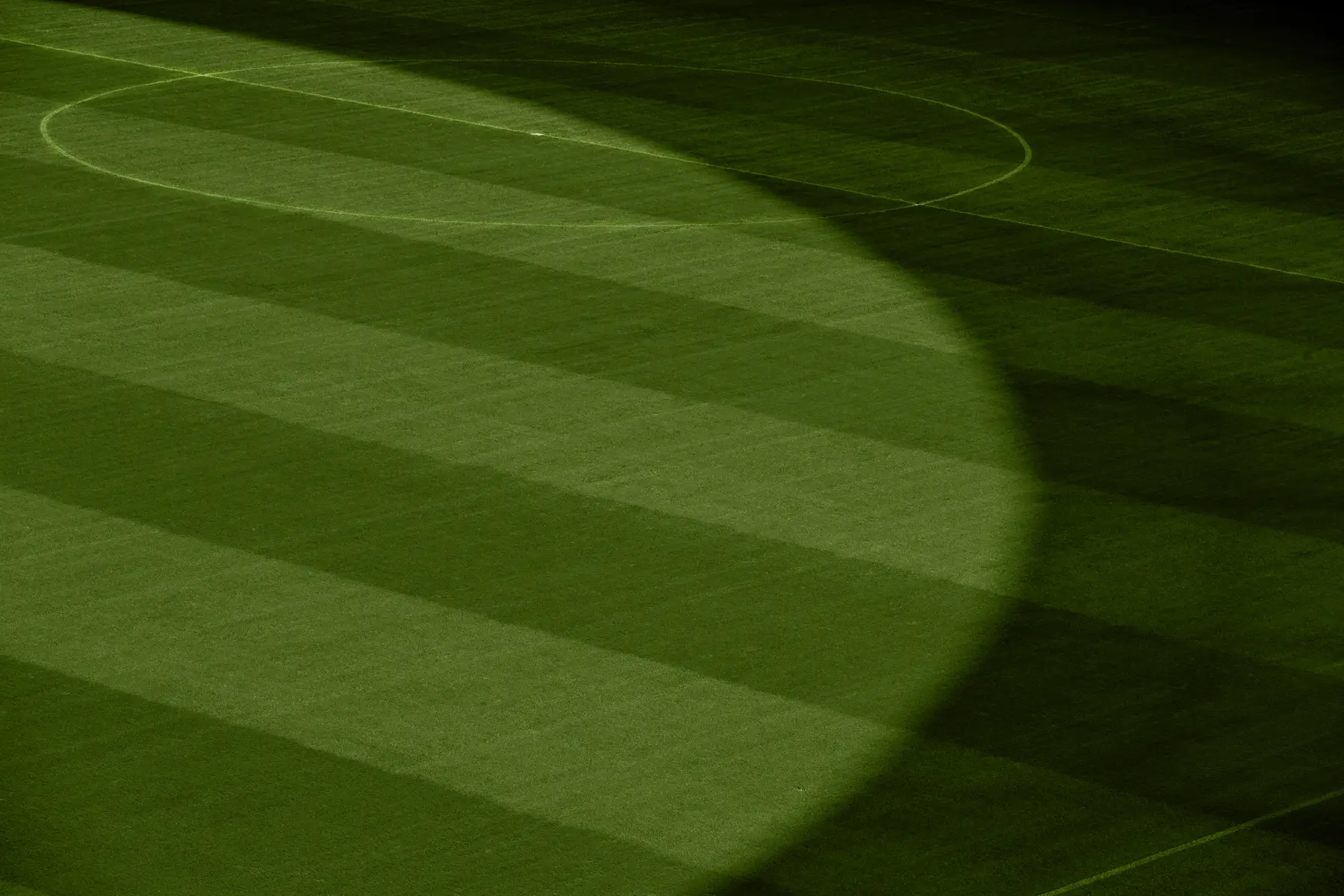 Grafismo do gramado do Estádio Mané Garrincha em Brasília, com faixas verdes e iluminação central