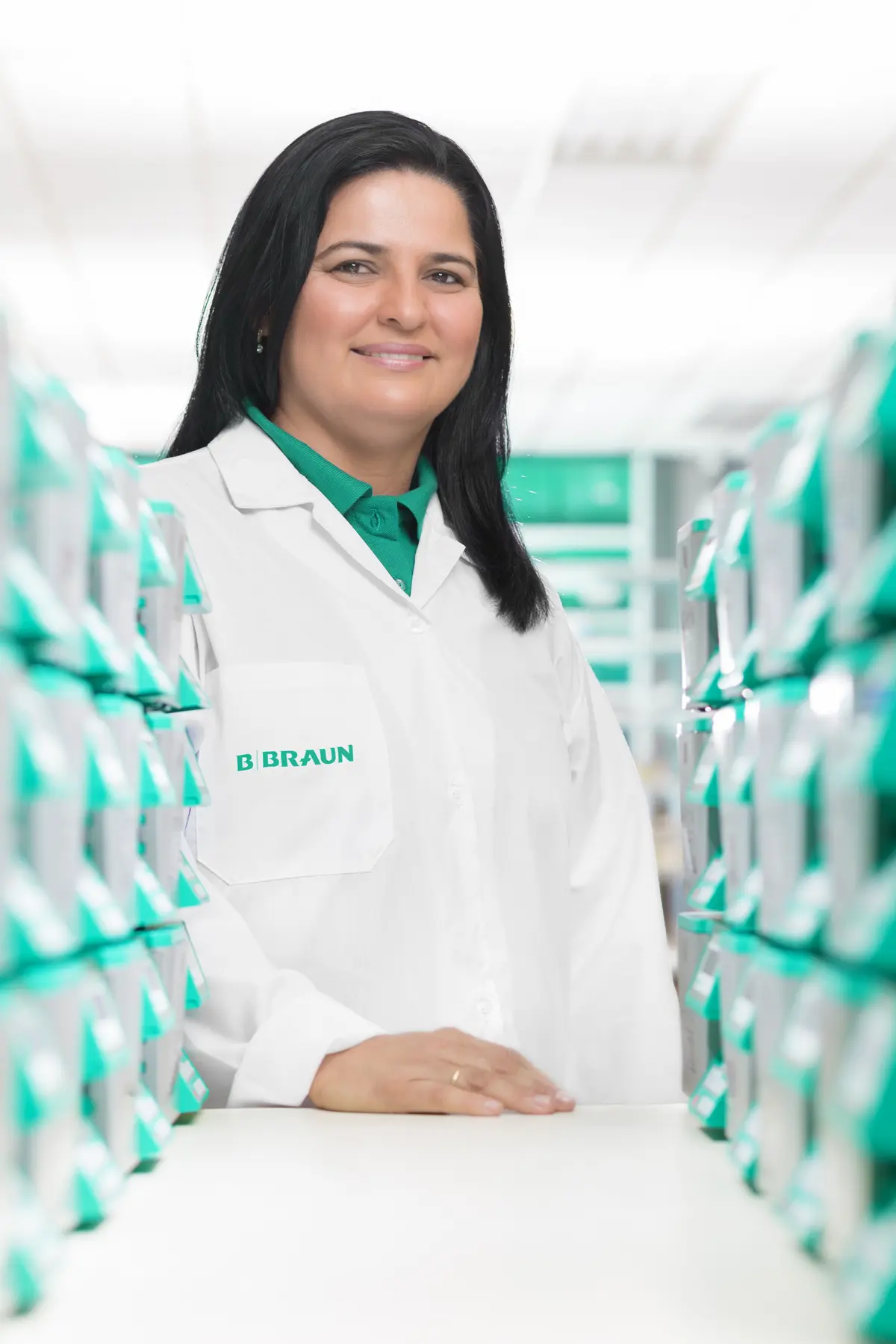 Colaborador da B. Braun em área de estoque técnico com caixas organizadas de produtos médicos.